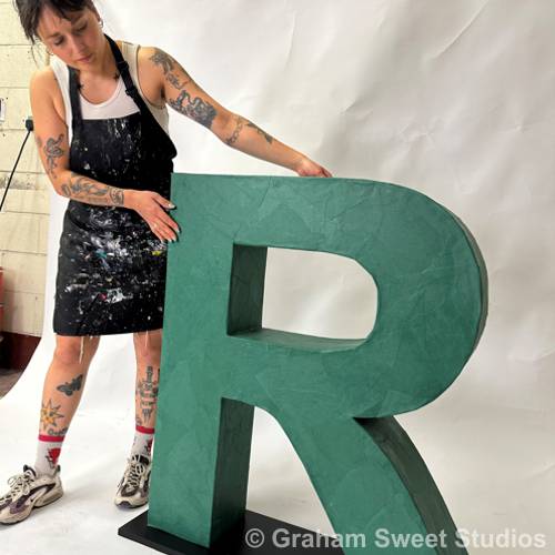 Cardboard letters showing plain and papier-mâché finish options