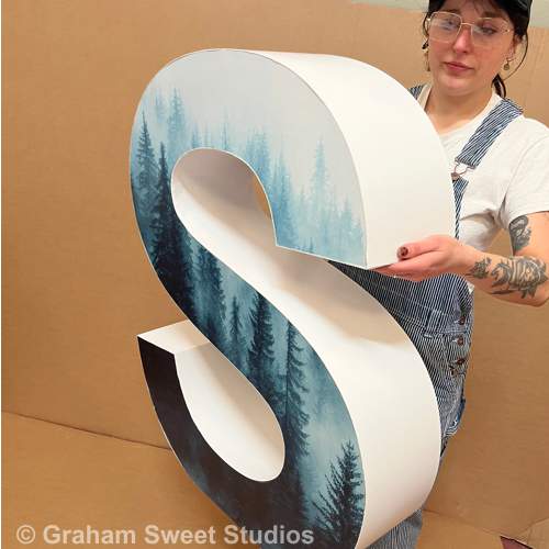 Large cardboard letters with full-colour printed faces
