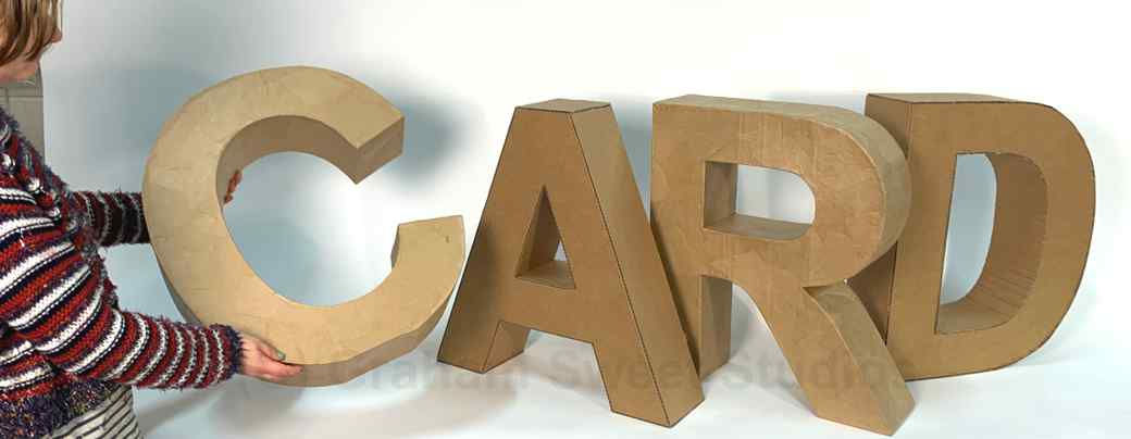 Large freestanding cardboard letters in a natural card finish