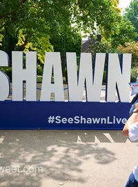 Large white SHAWN LIVE letters at an outdoor event