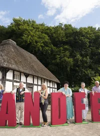 People standing behind large red GRANDFEST letters