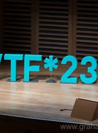 Turquoise WTF23 letters on an event stage