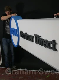 Workshop team manufacturing a large Dell PartnerDirect sign