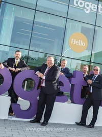 Together team members standing with large purple branded office letters