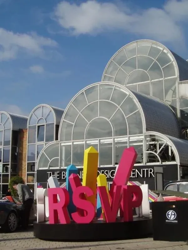 Colourful freestanding RSVP letters outside a design centre