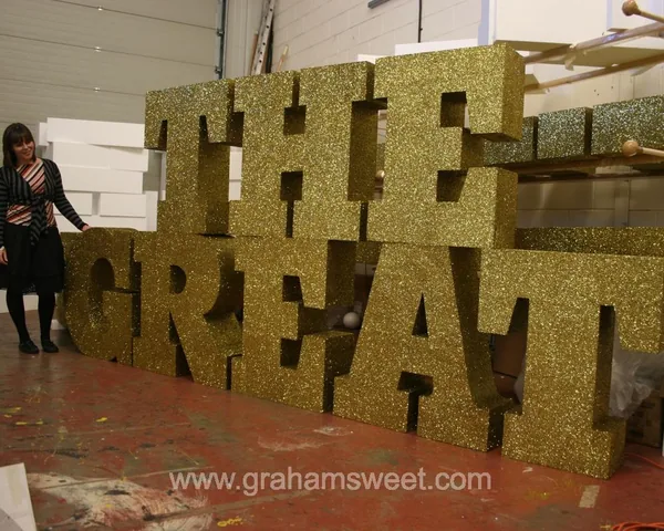 Large gold glitter polystyrene letters demonstrating bespoke sizes and fonts