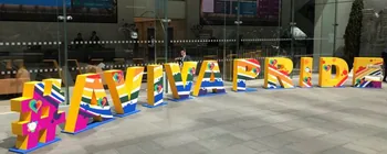 Colourful AVIVA PRIDE letters displayed outside an Aviva building