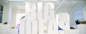 Large white BIG IDEAS letters displayed in a Clarks showroom