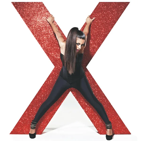 Konnie Huq posing with a giant red glitter letter X