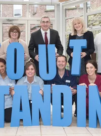 The Christie NHS team holding large OUTSTANDING letters