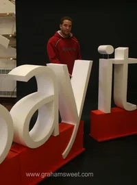 White Say It letters on red display bases