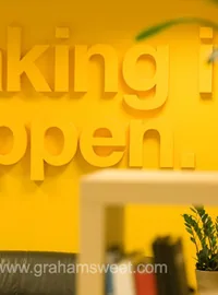 Raised Making it happen lettering on a yellow wall