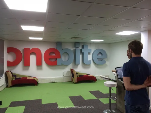 One Byte dimensional logo mounted on an office wall