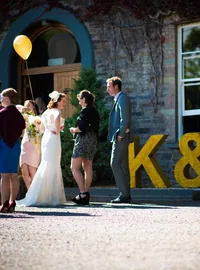 Wedding reception beside gold glitter K and M initials