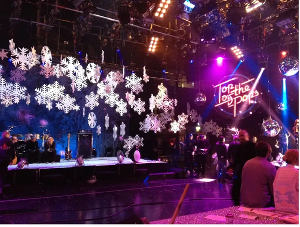 Large white snowflakes suspended above a winter themed event set