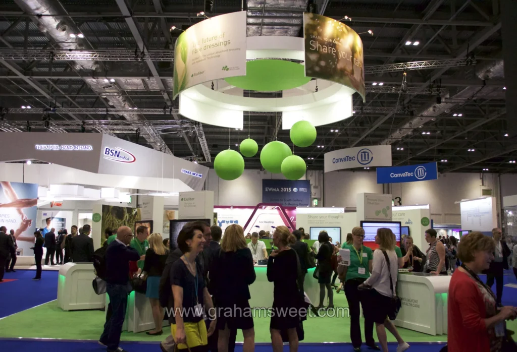 Mölnlycke exhibition stand with large green polystyrene balls suspended overhead