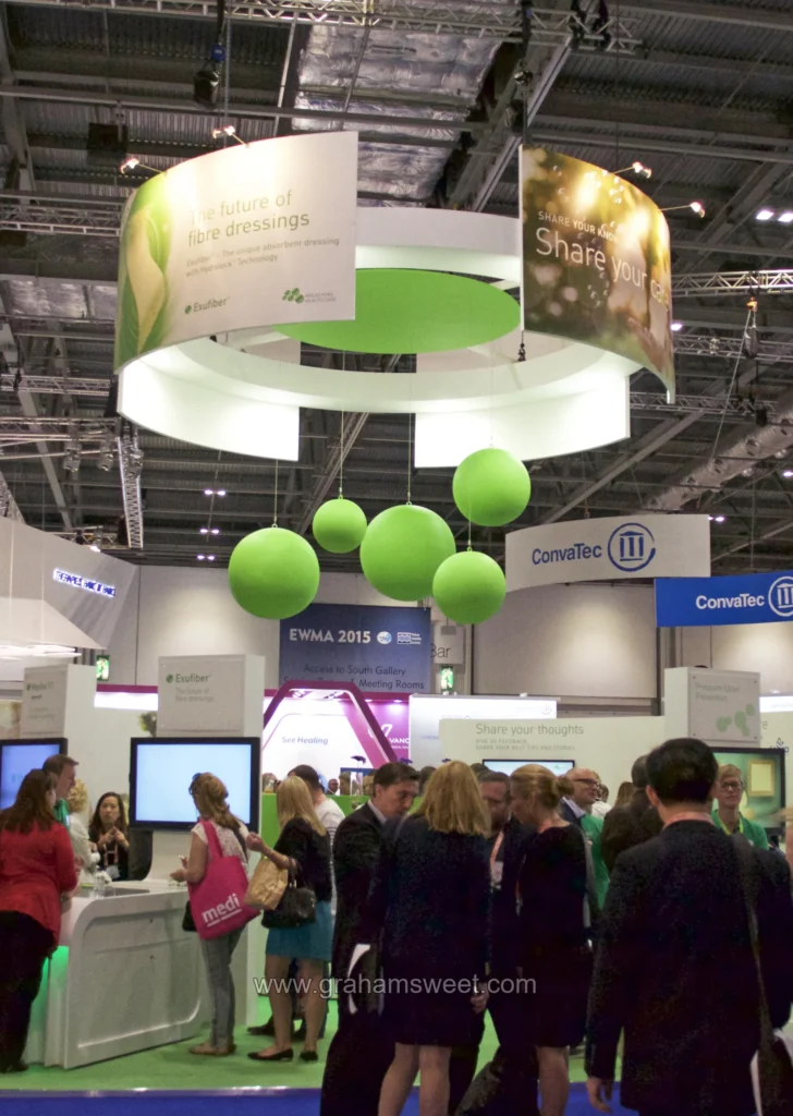 Cluster of green hanging polystyrene balls above the Mölnlycke exhibition stand