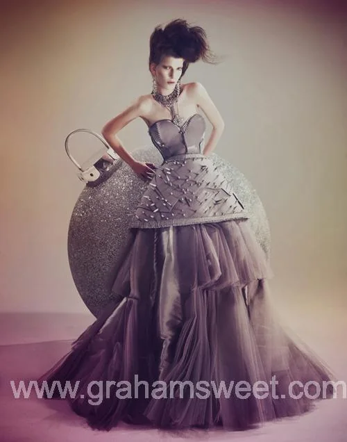 Model posing with a giant silver glitter bauble for the Financial Times fashion shoot