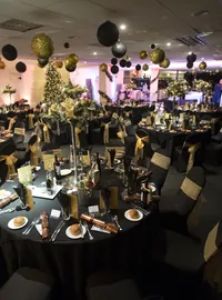Large hanging baubles above tables at a Christmas event