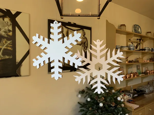 Large white cardboard snowflakes in an interior display