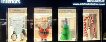 Christmas shop windows featuring Father Christmas and festive props