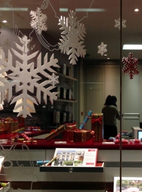 polystyrene snowflakes in the windows of Strut and Parker.