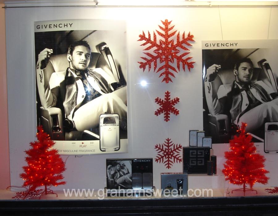 red glittered snowflakes window display