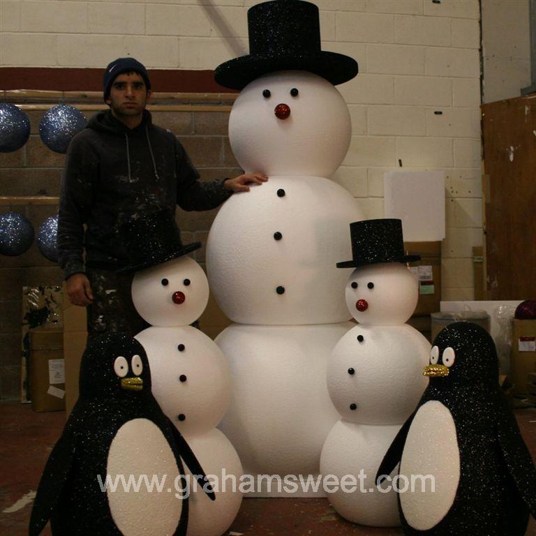 giant snowmen with penguins
