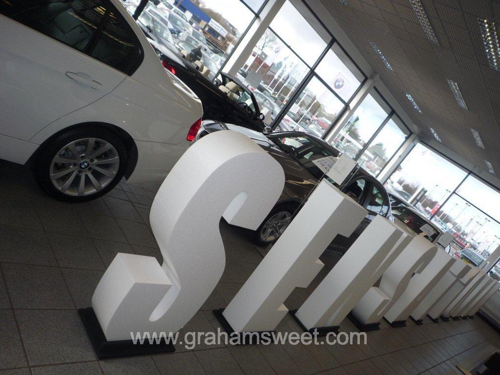 poly letters in BMW garage.