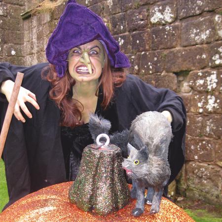 Witch with large glittered pumkin