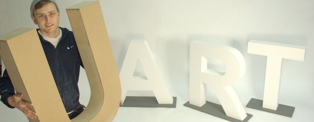 Large bespoke wooden letters in natural and painted finishes