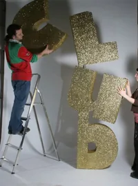 Large gold glitter letters in production