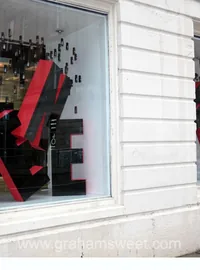 Black and red letters installed in a shop window