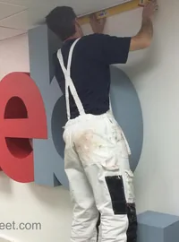 Large red wall letters during installation